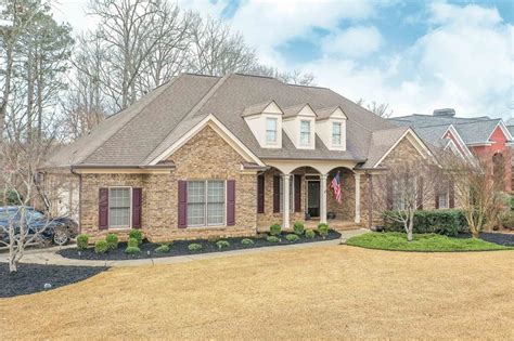 3435 stembler rdg douglasville ga 5BA (2 en-suites), entryway and formal LR w/17' ceilings, grand formal DR with tray ceiling and judge's panels, family room w/13' ceiling & masonry fireplace steps out to a charming screened lanai