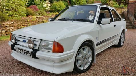 86 ford escort rs for sale 5L engine, two-tone paint as seen in this one, the steering wheel was wrapped in leather, a luggage rack on the deck lid, a fancier stereo system, a