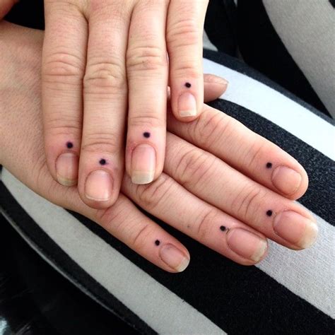 Black dots on fingers tattoo meaning A blue nevus is typically blue or gray, but it can sometimes be yellowish-brown