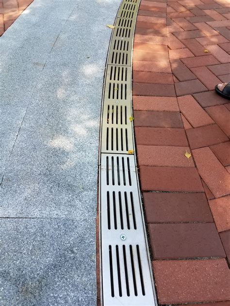 Curved trench drain  A trench drain is a floor drain that generally consists of a trough or channel-style body with a slotted grate that sits on top to prevent people and large solids from entering the drainage system