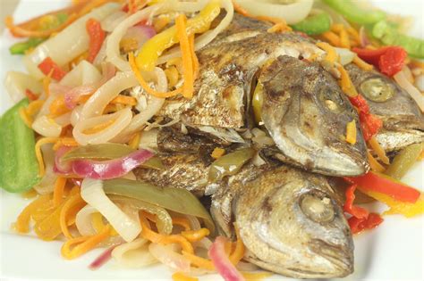 Escovitch fish origin  Brown stew fish is a Jamaican delicacy made by combining marinated and fried fish fillets with a brown sauce consisting of onions, garlic, ginger, tomatoes, butter, and water