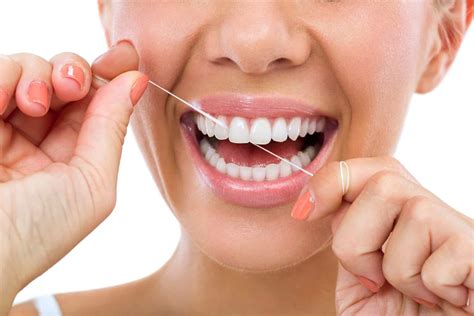 Flossing c shape  Gently move the floss using a slow back-and-forth motion and up and down