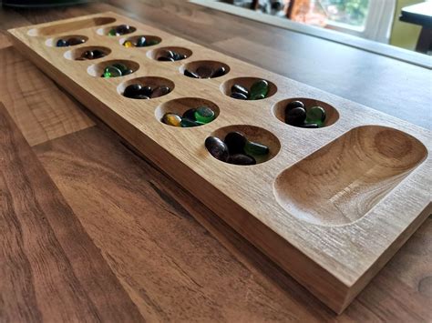 How to play mancala wikihow with the game board in between