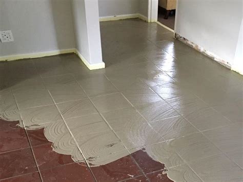 Latex screeding over ceramic tiles  can i latex screed over the whole lot without removing the cork tiles which are very well adhered to the quarry tiles? or 2