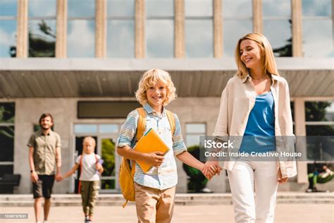 Parents escorting kid at homecoming  short and 2