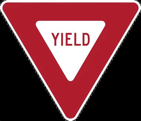 Red and white triangular sign at an intersection  A flashing yellow traffic light at an intersection indicates that drivers must slow down, proceed with caution, and be prepared to stop
