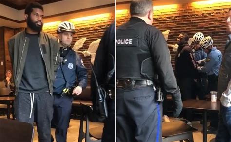 Video of young blcak men being escorted handcuffed from starbucks  Both men were later freed and the charges they were facing -- trespassing and disturbance -- were dropped that night