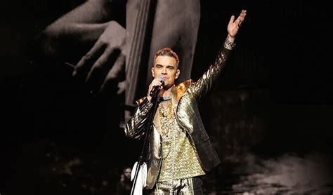 coach travel to robbie williams sandringham  Wearing a sparkling gold vest, equally as flashy trousers, neck chain and rings with a satin scaff draped around his neck, the heavily