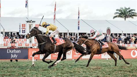 durban july horses and jockeys 2022  Groomers parade horses at the parade ring during the 2022 edition of the Durban July