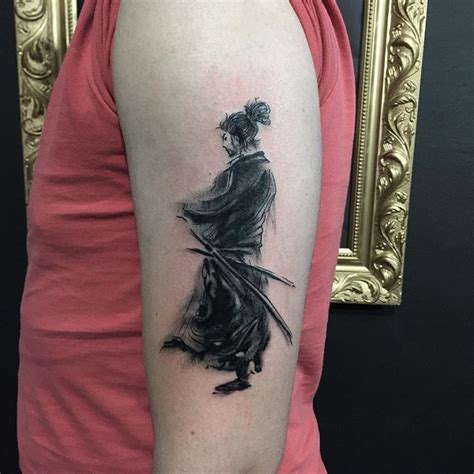 miyamoto musashi tattoo joe rogan  a man's leg with a tattoo on it that has an image of a person holding