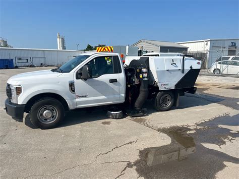 ph250 pickup sweeper This disclosure relates to a sweeper for roads, parking lots or like surfaces which is particularly adapted to be mounted upon a bed of a pickup truck, the sweeper including a hopper into which air-entrained debris is discharged, the hopper having a fore-aft axis to coincide with the direction of travel of an associated pickup truck, a pickup head, the