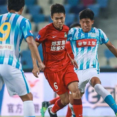 zhejiang hangzhou v henan jianye 18' Henan Songshan player Adrian Mierzejewski strikes the shot off target, ball is cleared by the Wuhan Three Towns