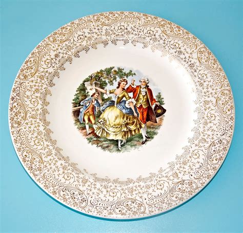 A 1959 calender ivory plate and 22kt gold printing with wide floral filigree rim by Royal China in the USA. Plate 832 (2k) $ 15.00. Add to Favorites 2 Vintage Royal China Warranted 22Kt Gold Colonial Saucers $ 4.00. Add to Favorites Royal China Pair Coupe Soup Bowls Swirl Quban Pattern Pink Yellow Roses 22Kt Gold Edge 8" Across Vintage MCM .... 