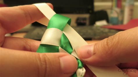 Easy-to-follow tutorial showing how to make a Double Braided Ribbon Lei in 3 colors. The lei requires about 6 yards of Red color, 6 yards of Blue color and 12 yards of the White....