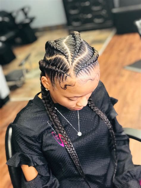 4 Braids Woman, The name describes the different sizes of the cornrows used  to create the style.