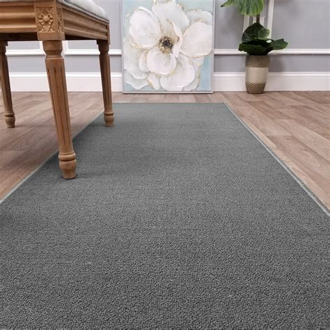 This beautiful runner rug offers a durable stain-resistant low pile for practicality, longevity, and easy cleaning. The non-slip rubber backing stays in place safely for you and your loved ones including your pets. Perfect for hardwood, tile, and marble floors that gets a lot of traffic. Pile Height: 0.2'' Construction: Machine Made; Material ....