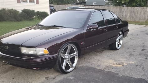 96 impala ss on 24s. just got a new used motor put in...not runin to bad!!! that noise was the gas tank cover 