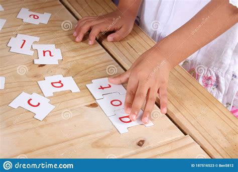 A Child`s Hands Moving Letters To Make a Word Stock Image Image of