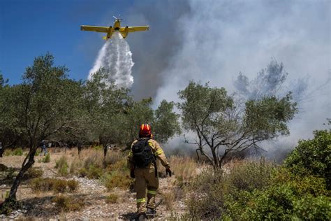 A firefighting plane crashes as new evacuations are ordered in Greece