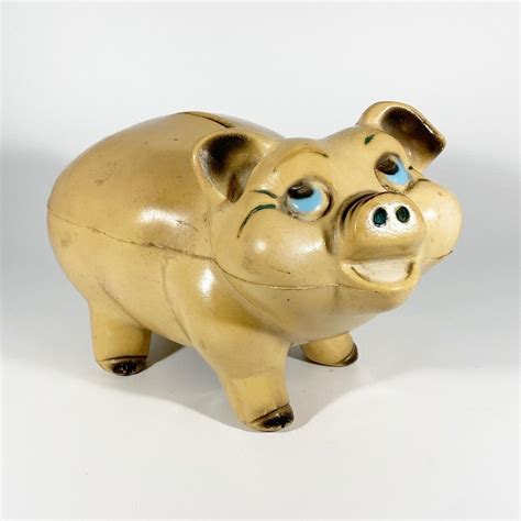  An absolutely adorable find! This light blue pig bank from A.N. Brooks LTD has an intact plug at its base. The engraved stamp also includes MERCHANDISE MART – CHICAGO – MODEL NO. 444 – PATENTED. Gold paint is accented on feet, tail, ears, and face, including a starburst on its top. Light pink is . 