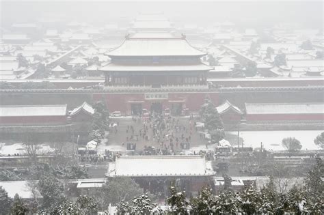 AP PHOTOS: Crowds bundle up to take snowy photos of Beijing’s imperial-era architecture