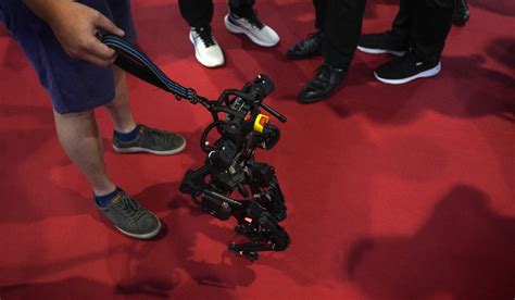 AP PHOTOS: Lifelike robots and android dogs wow visitors at Beijing robotics fair