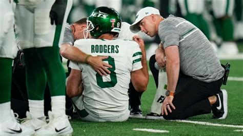 Aaron Rodgers carted from sideline after suffering ankle injury in his first series for Jets