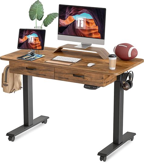 Adjustable desk with drawers. Slide it into position when you need it, then easily slide it back into place. The Mind Reader adjustable height overbed desk lets you enjoy lunch from a comfortable position, or work efficiently from anywhere in the house. Dimensions: 15.75" L x 23.75" W x 27.75" - 32" H Tabletop Surface: 15.75" L x 23.75" W. $43.99. 