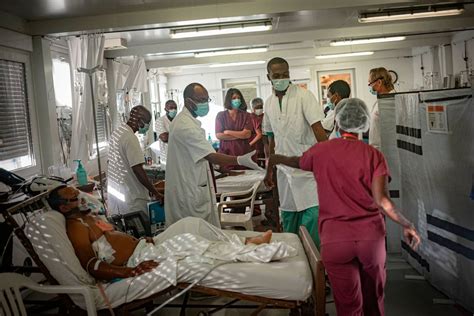 Aid group in Haiti suspends treatment after some 20 armed men storm hospital
