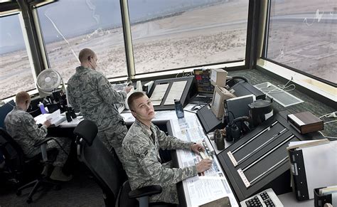 Air force air traffic control. U.S. Air Force Staff Sgt. David Kaylor and Airman 1st Class Quinton Garvin, air traffic controllers with the 245th Air Traffic Control Squadron at McEntire Joint National Guard Base, South Carolina Air National Guard, watch for airfield activity from the control tower on Nov. 6, 2011. (U.S. Air National Guard photo by Tech. Sgt. Caycee Watson) 
