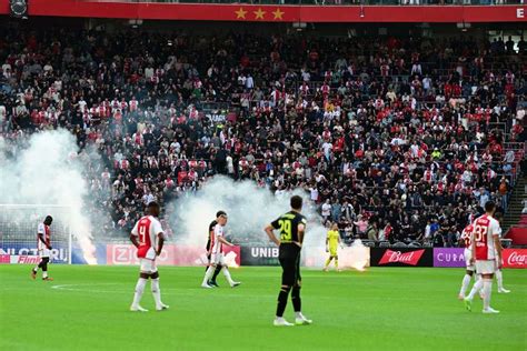 Ajax and Feyenoord’s Eredivisie match abandoned as fans throw fireworks on the field