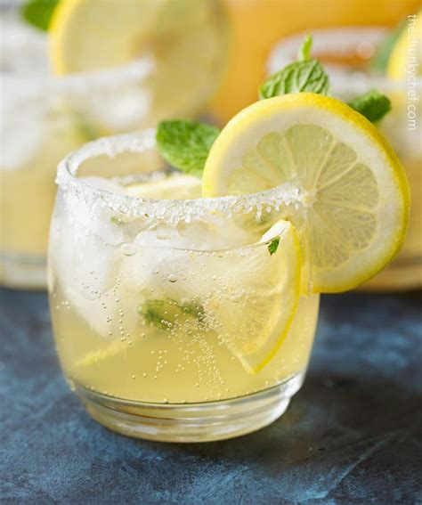 Alcoholic beverages with lemonade. Instructions. Squeeze lemons (straining seeds and pulp) to make 2 cups. Set aside. Hull strawberries, add to food processor. Puree for a few seconds. Add 1 cup of water and 2 tablespoons of sugar. Blend until it forms a liquid. Add strawberry juice to lemon juice in a large pitcher. 