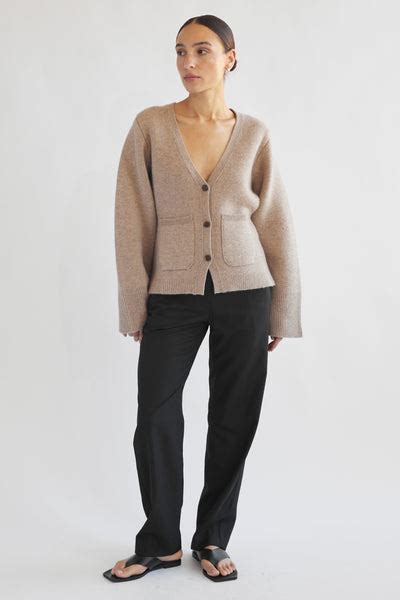 Almina concept. DETAILS Model is 5′8″, Wearing small Fit: Relaxed Material: Alpaca 17% Nylon 42% Wool 41% Care Instructions: Hand wash cold, lay or hang flat to dry. Dry clean for best result. Made In Seoul, Korea. DESCRIPTION Fuzzy alpaca blend sweater with a sheer quality and button up detailing. It's a soft relaxed fit sweater. 