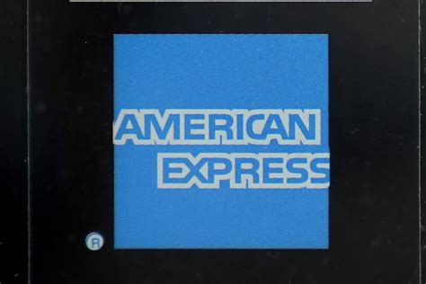 American Express profit rises, but it sets aside more money for possible defaults