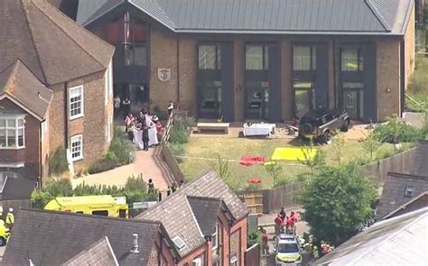 An SUV crash at a London school kills an 8-year-old girl. A woman is arrested for dangerous driving