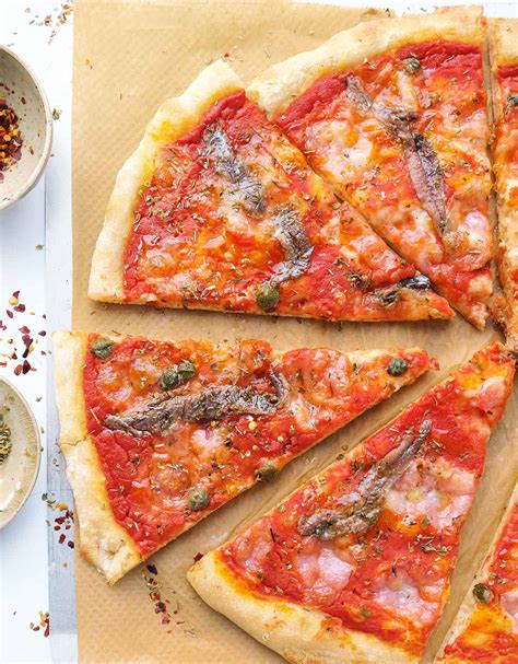 Anchovies pizza. Preheat oven to 220°C (200°C fan-forced). 3. Spread cooled sauce over base of pizza. 4. Combine cheeses in small bowl; sprinkle half the cheese over pizza, top with anchovies, capsicum and mushrooms. Sprinkle with olives and remaining cheese. Bake about 15 minutes or until crust is golden brown. Sprinkle with basil. 