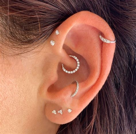 Anti-tragus. Build your perfect ear stack with our luxury piercing jewellery. Explore our dainty solid gold huggie hoops, helix, tragus and daith cartilage earrings, ideal for stacking. We ship worldwide from the UK. 