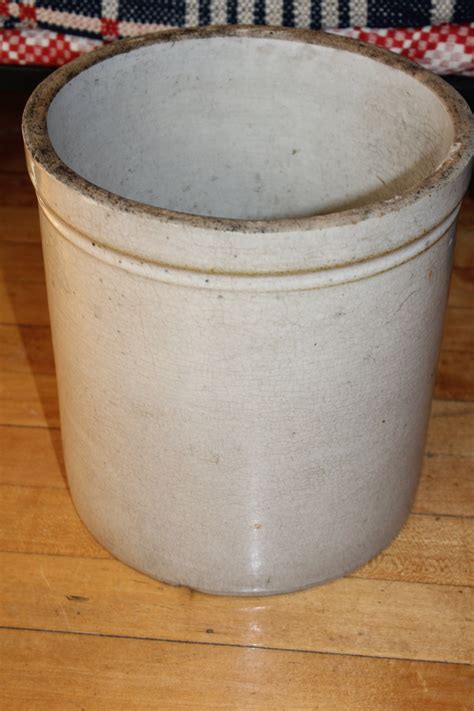 This is a great antique 1 gallon J. (Jacob) Fisher Lyons, NY primitive stoneware pottery crock with applied handles. This crock is in great original condition. It measures approximately 6 1/2 inches height, 7 1/2 inches base diameter & 8 inches across top outer rim. In nice vintage condition. Does