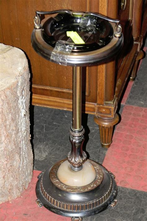 Antique metal ashtray stand. Art Deco ashtray stand, smoke stand, smoke standing ashtray, floor ashtray, cocktail smoker stand. An ashtray on a stand made from chromed metal and bakelite. ... A gorgeous Art Deco period acid etched silver floor standing smoker's stand ash tray By Tiffany Studios New York, USA, Early 20th Century Measures: 10"W x 10"D x 24.75"H Good ori ... 