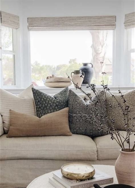 Arranging throw pillows on a sectional.  Throw pillows offer a simple yet effe...