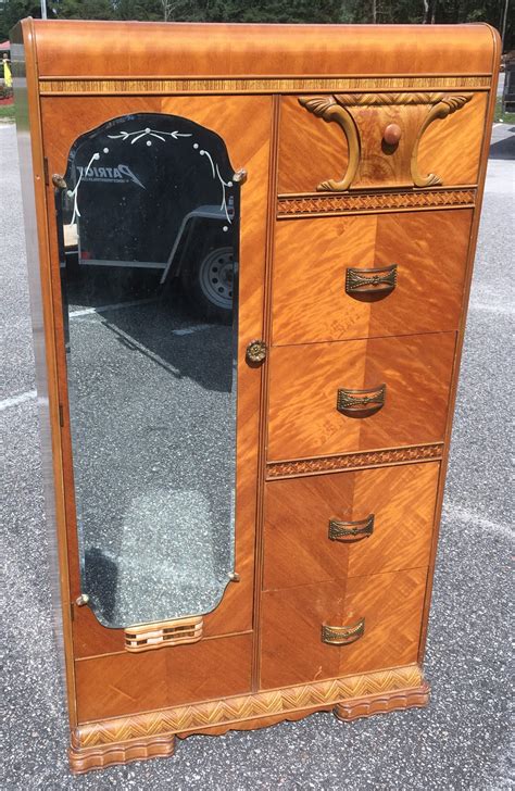 Art deco armoire. For Sale on 1stDibs - French Art Deco Armoire in macassar ebony with 2 center mirrored doors and 2 outer doors with marquetry. Interior drawers and shelves. 