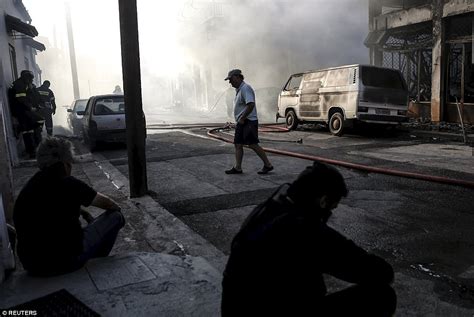 As wildfires rage in Greece, tourists flee and locals shelter