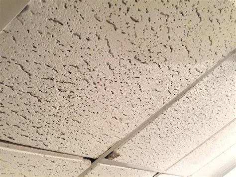 Asbestos ceiling tiles. Asbestos-containing drop-in tiles are square or rectangular, placed in a grid system on the ceiling. They can have a smooth or textured surface and are commonly found in places like office buildings and schools. By contrast, sprayed-on ceilings consist of a mixture of asbestos fibres, binders and water, creating a … 