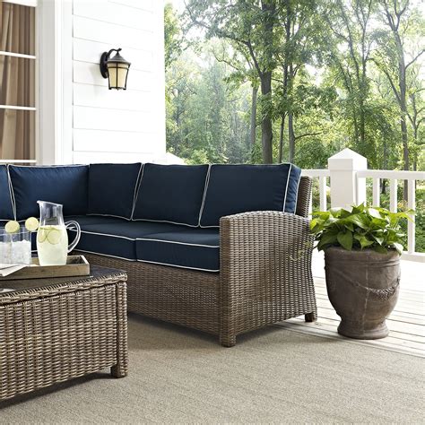 Cozy up in the luxury of the Bradenton 5pc Sectional Set. Sectional seating for up to six hugs the powder-coated steel fire table offering deep seat cushions on all-weather resin wicker. The sectional cushions are covered in a solution-dyed polyester for durability and comfort. The fire table's tiled stone top and lattice paneled base offer a unique design that elevates any outdoor space. The ... .