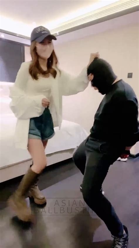 Asian girls busting balls.  They take a brief break before continuing the assau...