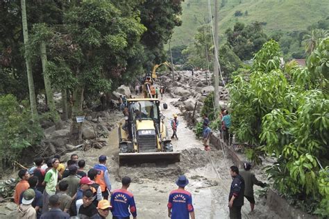 At least 12 people are missing after heavy rain triggers a landslide and flash floods in Indonesia