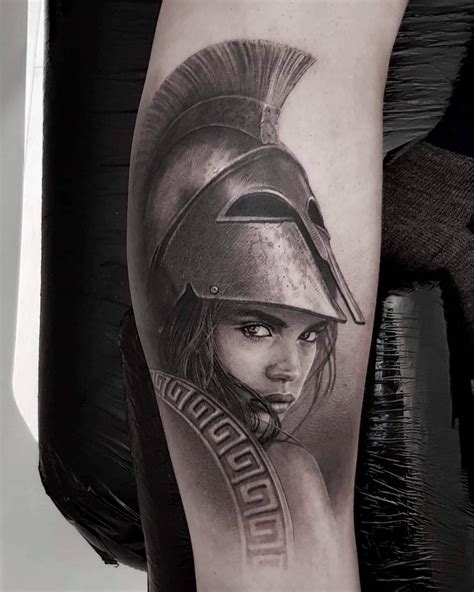 Athena tattoo. Try a Temporary Tattoo. Athena, not only revered as the deity of wisdom and warfare but also the patron goddess of Athens, was a symbol of peace and handicraft as well. Her detailed black and grey tattoo portrayal often features her with a spear, her favored weapon in mythology. She resided on Mount Olympus with 12 other deities. 