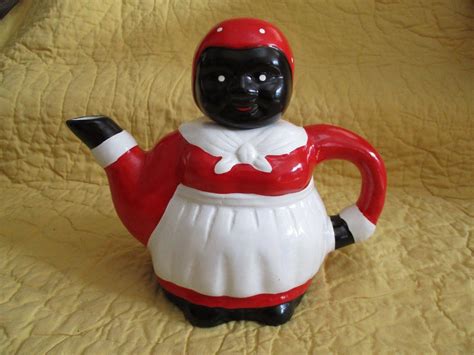 Aunt Jemima Souvenir Tea Bell - Vintage 1940s - Baton Rouge LA - Hollander Novelty Co. - Black Americana Aunt Jemima Souvenir Tea Bell has a wooden handle decorated with a face, dressed in red and white gingham for a dress and kerchief, with white organdy shawl and apron. The metal bell has a