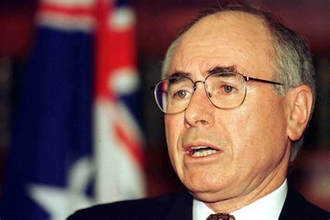 Australian Prime Minister John Howard shields his eyes from the …