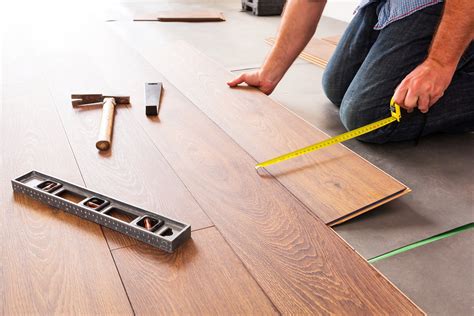 Average cost of flooring removal and installation. The average cost of laminate flooring is $1–$4* for the laminate itself and another $4–$8 for professional installation. That means the total cost of laying down laminate flooring in a 200-square-foot space is between $1,000 and $2,400. We’ll go over various cost considerations and details below. 